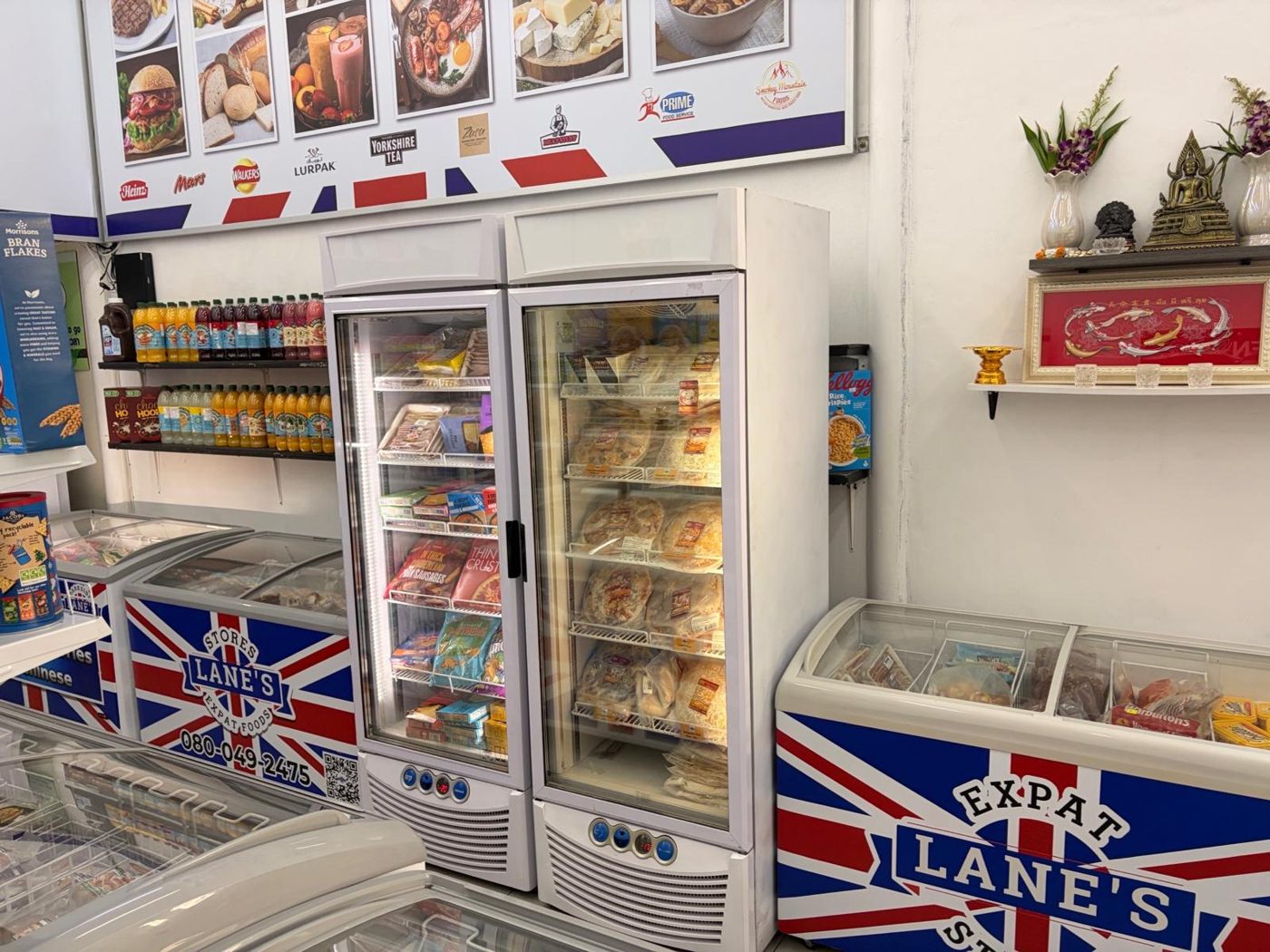 Fridge of frozen pies and ready meals beside a Union Jack freezer