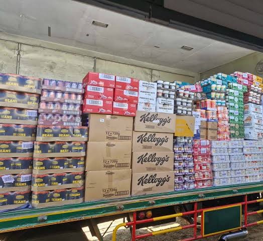 A delivery truck loaded with British foods including beans and cereal